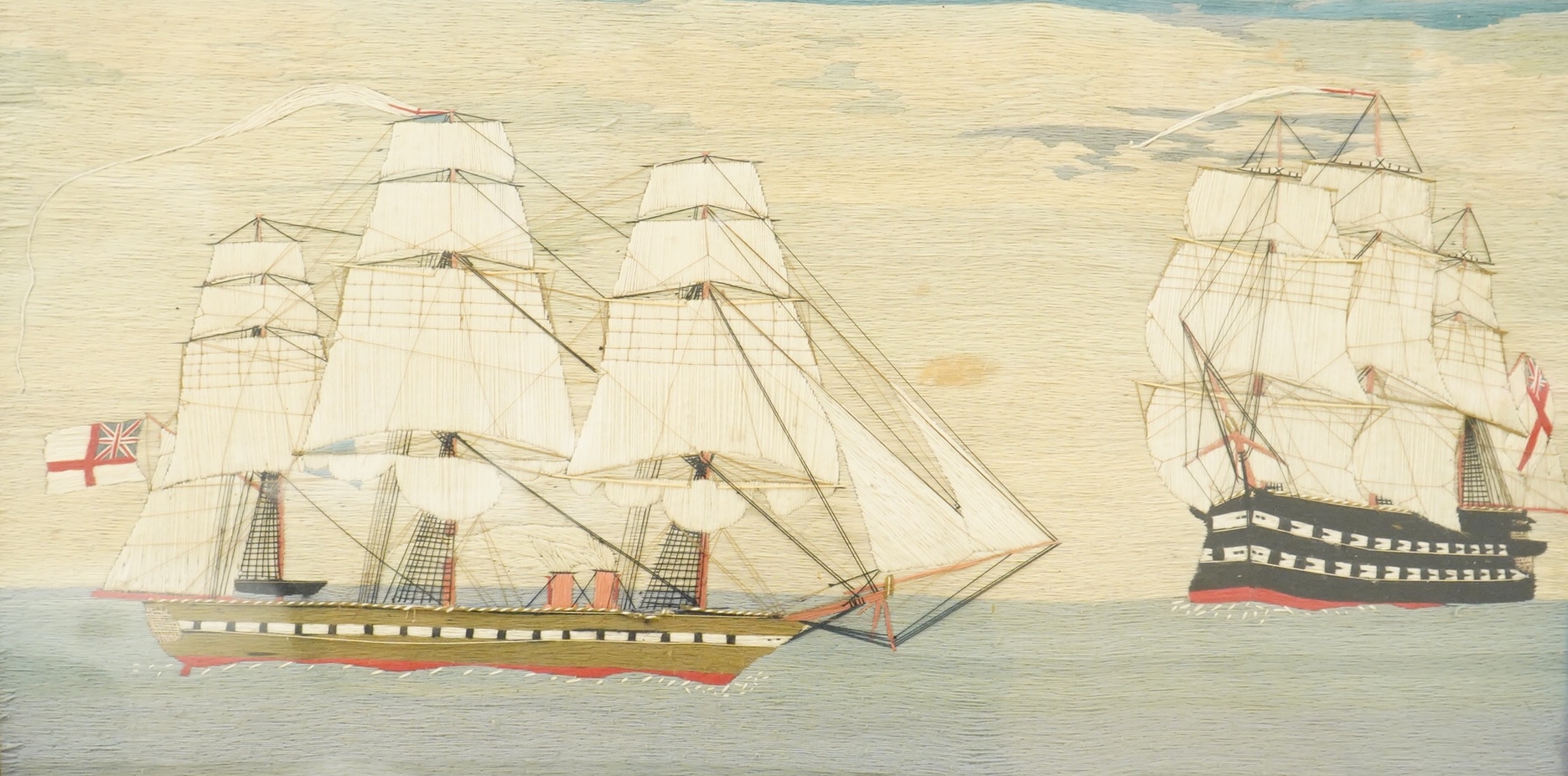 A large 19th century folk art ‘sailors woolie’ embroidery, of a naval steam ship and a frigate, both flying the Royal Navy ensign. 74cm x 39cm.